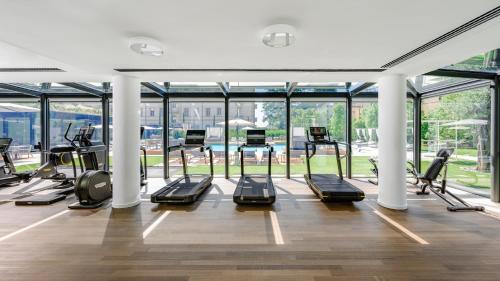 a gym with several treadmills and elliptical machines at Grand Hotel Victoria concept & spa, by R Collection Hotels in Menaggio