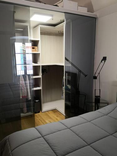 a bedroom with a bed and a glass wall at Casa del Conte Massimiliano Roero in Cuneo