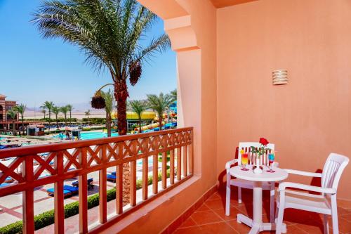 a balcony with a table and a view of the pool at Charmillion Club Aquapark in Sharm El Sheikh