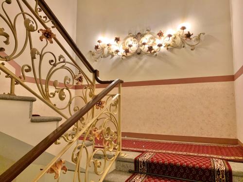 a staircase with a chandelier on the wall at Continental Parkhotel in Lugano