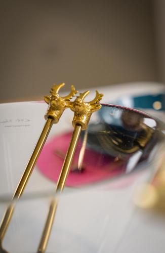 two gold sticks sitting on top of a table at Apartment VAZATAOR with sauna in Brežice