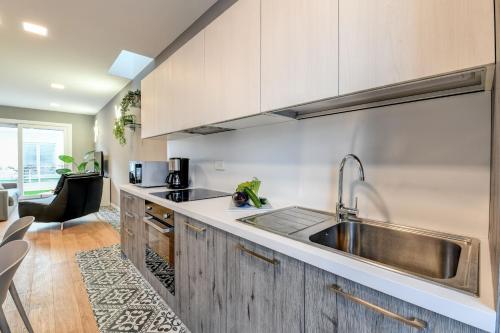 a kitchen with wooden cabinets and a sink at Villette Dolci Luxury Homes in Peschiera del Garda
