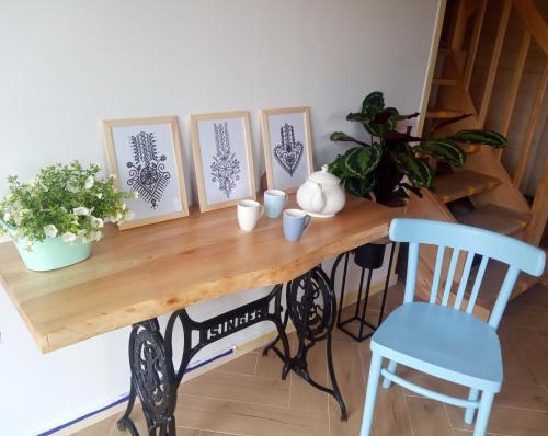 a table with four pictures on it with a blue chair at Gazdówka - najlepsza miejscówka domek w Pieninach in Krościenko