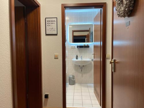 a bathroom with a sink and a mirror at Apartment Modern Stylish-kitchen,BLK near Fair-Bosch Forschung-Zentrum in Renningen