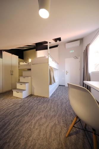 an empty room with a desk and a chair at Downtown Boutique Hostel in Zadar
