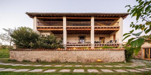 a building with a staircase in front of it at El Rebastral - Mas Vinyoles Natura in Sant Pere de Torelló