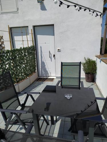 a table and two chairs on a patio at Relais Il Giardino fra gli Ulivi in Torino di Sangro