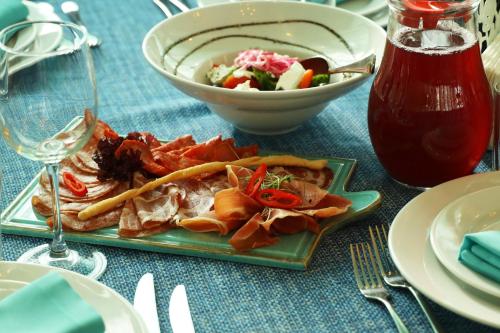 a table with a plate of food and a bowl of salad at Biruza Club in Svyatopetrivske