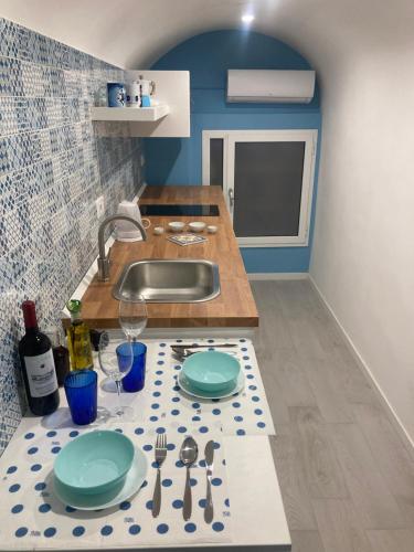 a kitchen with a counter top with plates and utensils at Casa Maradona in Naples
