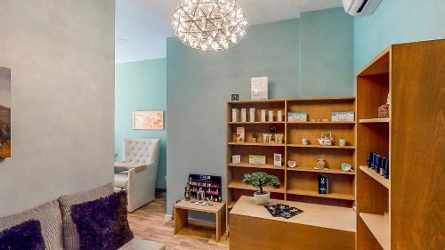 a living room with a book shelf and a table at Urban Oasis Aparthotel in Cape Town
