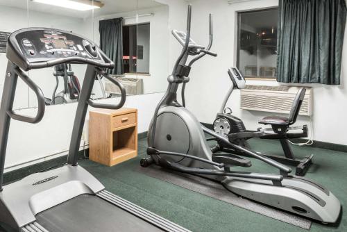 a fitness room with a treadmill and a chair at Super 8 by Wyndham New Stanton in New Stanton
