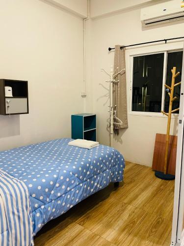a bedroom with a bed and a window at Dragon XIV in Bangkok