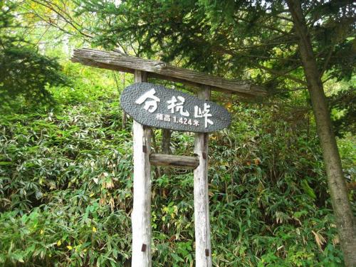 a street sign in front of some trees at Guesthouse YadoyaDOYA in Miyada