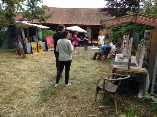 a woman standing in the grass at an outdoor event at B&B De Henehoeve in Heks