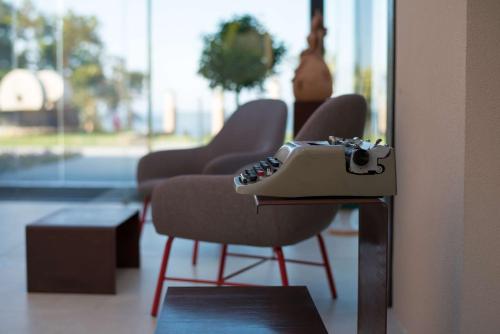 a pair of chairs in a room with a mirror at Best Western Plus Hotel Terre di Eolo in Patti