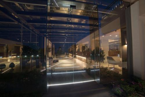 a lobby of a building with glass walls at Best Western Plus Hotel Terre di Eolo in Patti