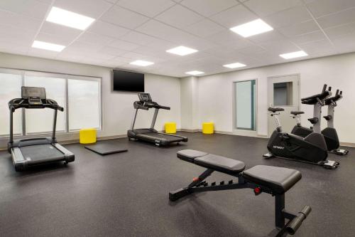 a gym with several treadmills and exercise bikes at Microtel Inn Suites by Wyndham Lac-Megantic in Lac-Mégantic