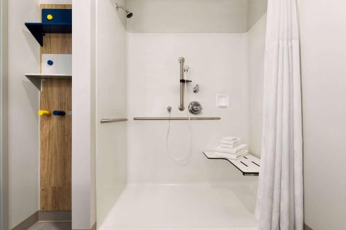 a bathroom with a shower with a shower curtain at Microtel Inn Suites by Wyndham Lac-Megantic in Lac-Mégantic