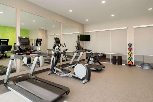 a gym with several treadmills and elliptical machines at La Quinta Inn & Suites by Wyndham San Antonio Seaworld LAFB in San Antonio