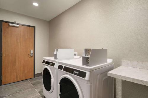 a white washing machine with a box on top of it at La Quinta Inn & Suites by Wyndham San Antonio Seaworld LAFB in San Antonio