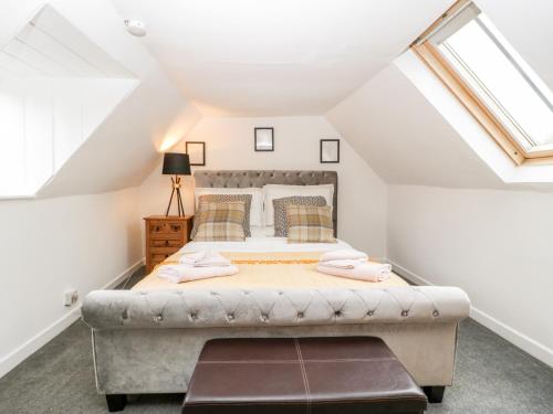 a bedroom with a large bed in a attic at 36 High Street in Salisbury