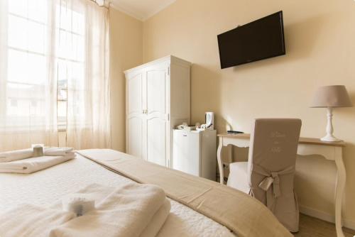 a bedroom with a bed and a television on the wall at Affittacamere Casa Dane' in La Spezia
