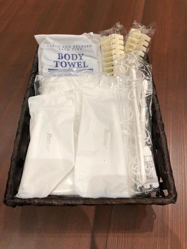 a suitcase filled with towels and other items on a table at Guesthouse YadoyaDOYA in Miyada