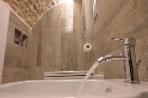 a bathroom with a sink and a shower at Pietrabianca Santa Maria Apartments in Manfredonia