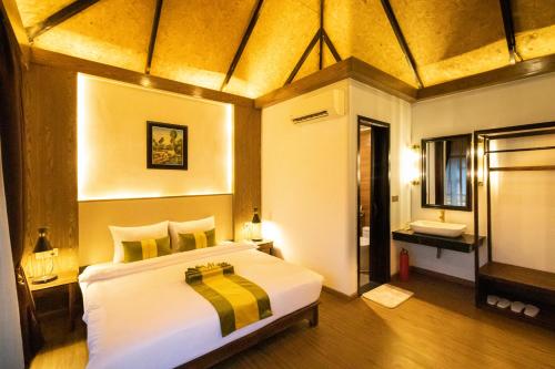 a bedroom with a large bed and a bathroom at Good Time Relax Resort in Kampot