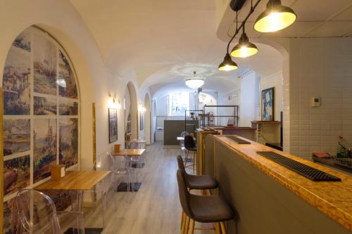a bar in a restaurant with tables and chairs at DCBoutiqueHotel in Rome