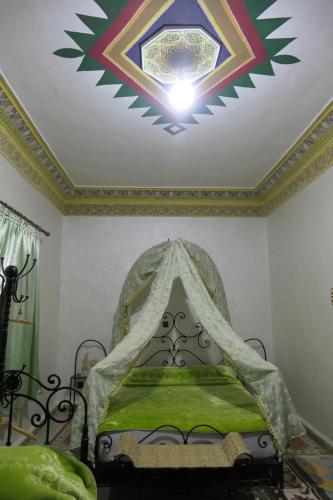 a bedroom with a bed with a star on the ceiling at Riad Maryam Taroudant in Taroudant