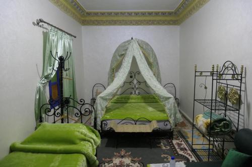 a bedroom with a bed with a canopy at Riad Maryam Taroudant in Taroudant