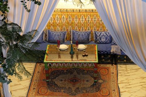 a living room with a couch and a table at Riad Maryam Taroudant in Taroudant