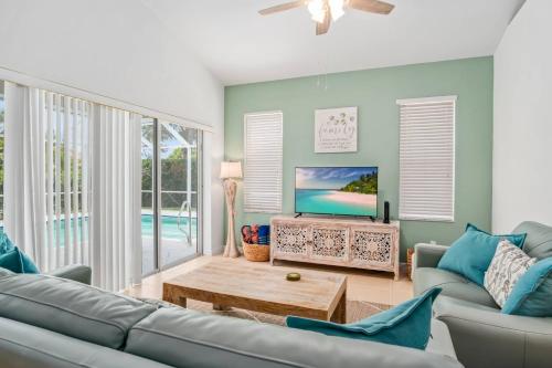 a living room with a couch and a tv at Tahiti House in Marco Island
