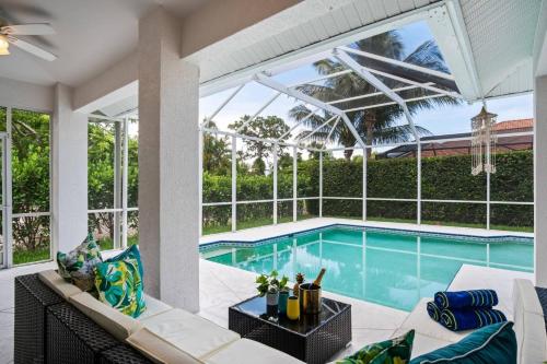 a living room with a swimming pool and a large window at Tahiti House in Marco Island