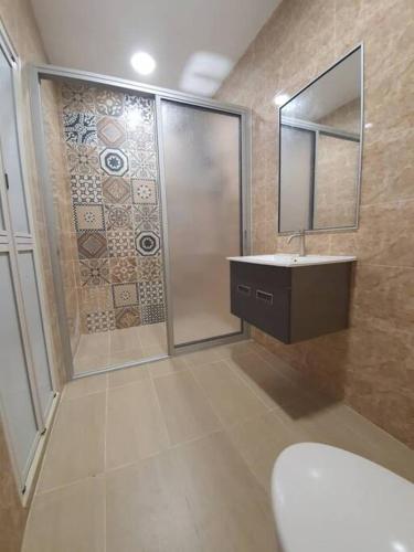 a bathroom with a shower and a sink and a mirror at PKA Residence at Taman Bentong Makmur in Bentong
