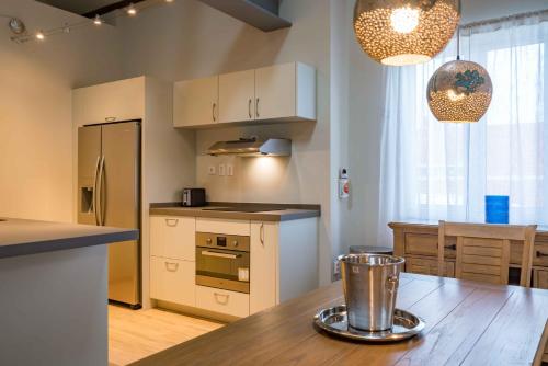 a kitchen with a wooden table with a counter top at La Casa Amarilla Apartments in Willemstad