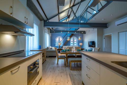 a kitchen and living room with a table and a dining room at La Casa Amarilla Apartments in Willemstad