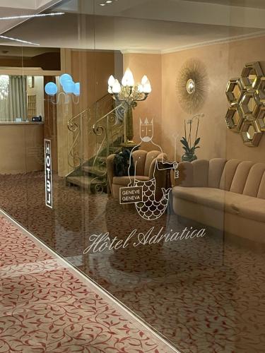 a living room with a couch and a staircase at Hotel Adriatica in Geneva