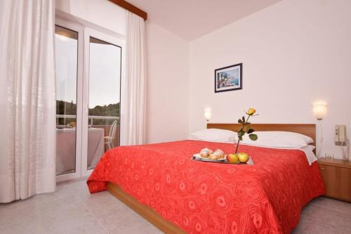 Postel nebo postele na pokoji v ubytování Hotel Carmen