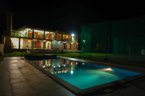 a swimming pool in front of a house at night at Villa Sarajevo in Vareš