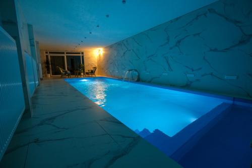 a swimming pool with blue lighting in a house at Villa Sarajevo in Vareš