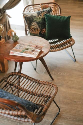 a table and two chairs and a table and a table and chairs at Le Domaine de l'Hostellerie in Le Fresne-Camilly