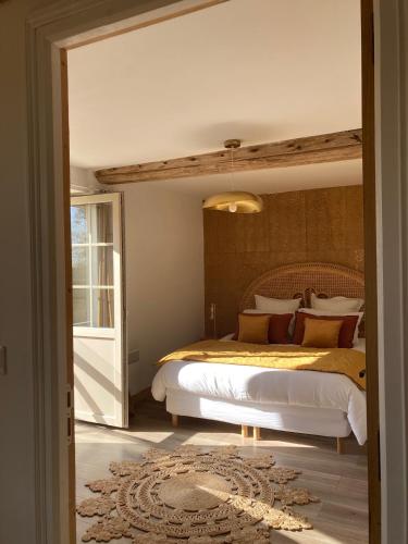 a bedroom with a king sized bed in a room at Le Domaine de l'Hostellerie in Le Fresne-Camilly