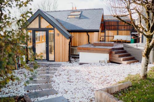 a house with a pathway leading to the front of it at Beavers Lodge. Luxury Property with Hot Tub in Tenby
