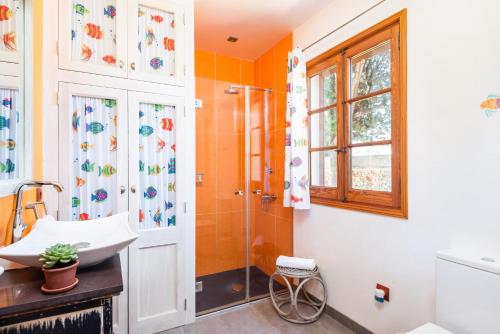 a bathroom with a sink and a shower at Villa Elena by Mauter Villas in Cala en Blanes