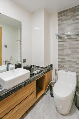 a bathroom with a white toilet and a sink at Hotel Casiana & Events Center Tagaytay in Tagaytay