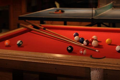 a group of billiard balls on a pool table at La Estancia Cabañas in Villa La Angostura