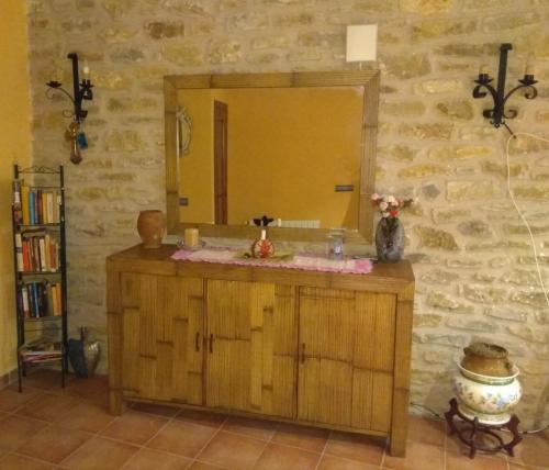 a bathroom with a wooden vanity with a mirror at Casa Costeta in Cinctorres