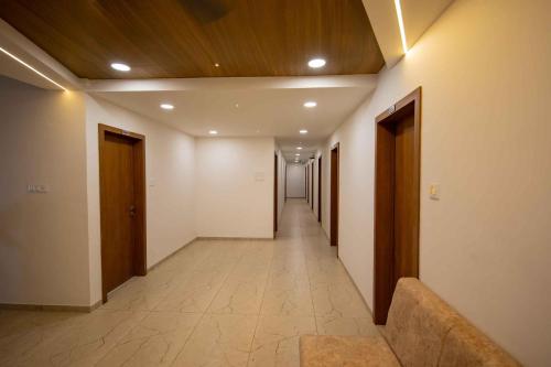 a hallway with a long corridor with wooden ceilings at HOTEL VENUS in Veraval